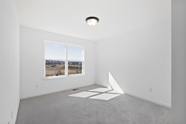 spare room with light colored carpet