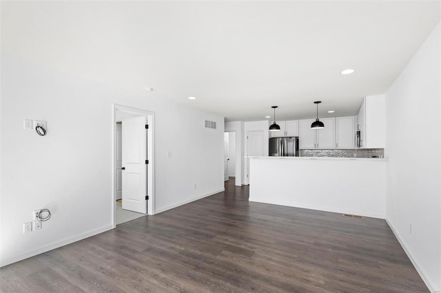 unfurnished living room featuring dark wood-type flooring