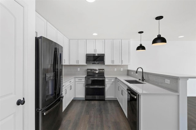 kitchen featuring pendant lighting, dark wood-type flooring, white cabinets, sink, and stainless steel appliances