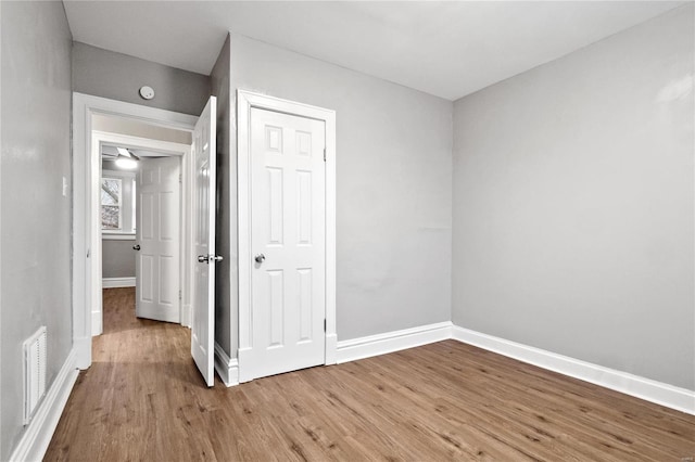 unfurnished bedroom featuring hardwood / wood-style flooring and a closet