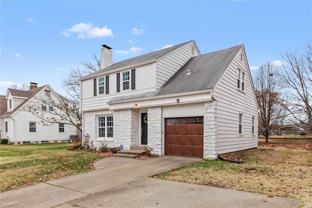 view of front of property with a garage and a front lawn