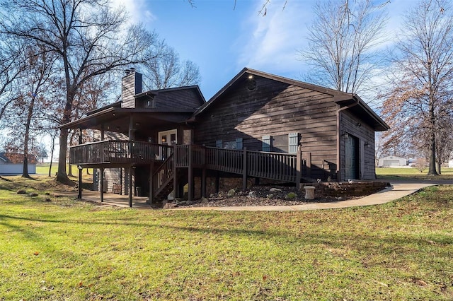 back of house with a lawn and a deck