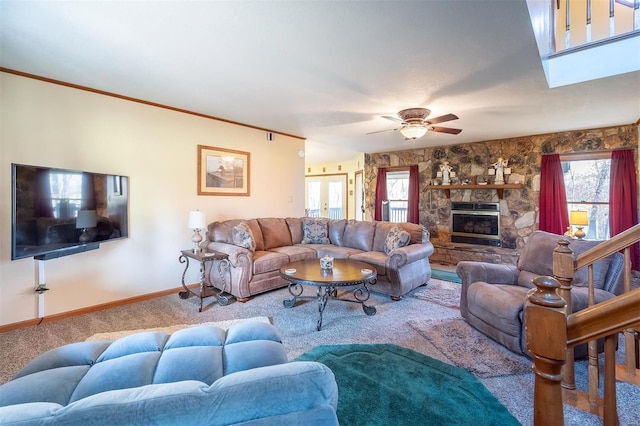 living room featuring carpet flooring, crown molding, ceiling fan, and a fireplace