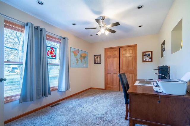 carpeted home office with ceiling fan