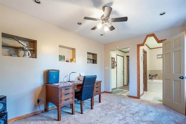 home office with ceiling fan and light carpet