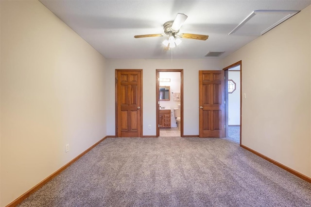 unfurnished bedroom featuring ceiling fan, light colored carpet, and ensuite bathroom