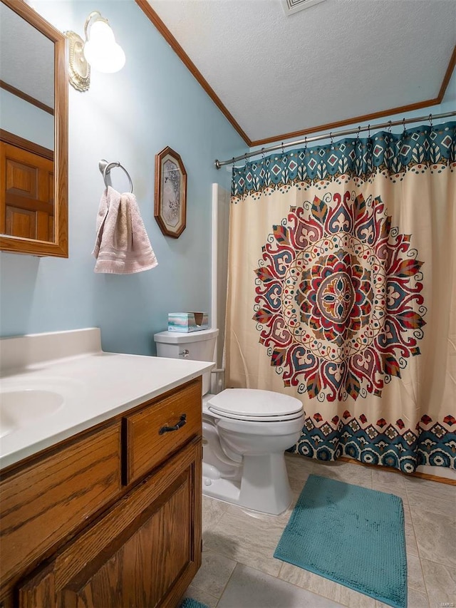 bathroom with tile patterned floors, vanity, a textured ceiling, crown molding, and toilet