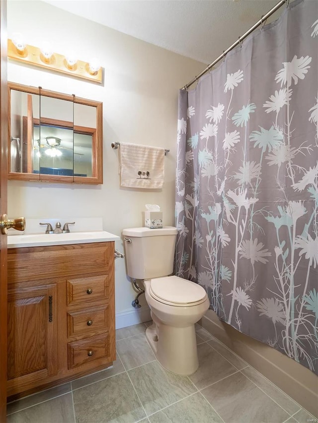 bathroom with tile patterned floors, a shower with curtain, vanity, and toilet