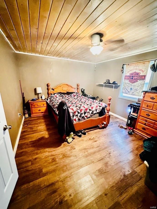 bedroom featuring ceiling fan, dark wood-type flooring, and wood ceiling