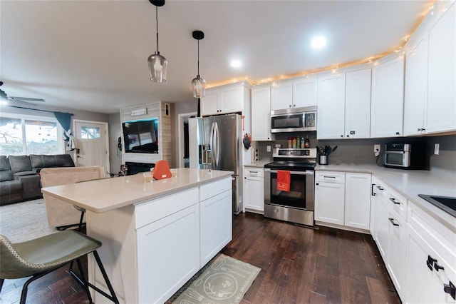 kitchen featuring white cabinets, dark hardwood / wood-style floors, and stainless steel appliances