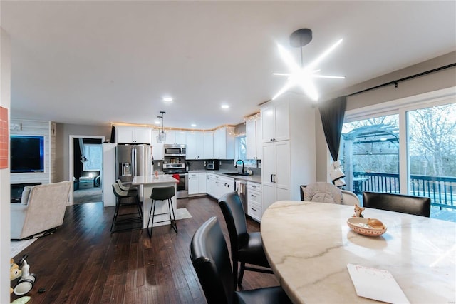 dining space featuring dark hardwood / wood-style floors and sink