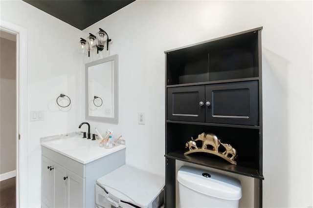 bathroom featuring vanity and toilet