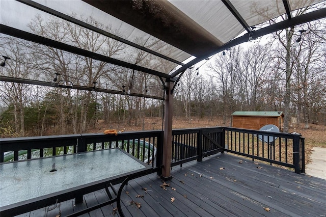 wooden deck featuring a storage unit