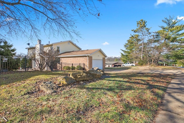 view of side of property with a yard and a garage