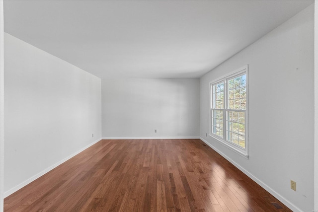 spare room with dark hardwood / wood-style flooring