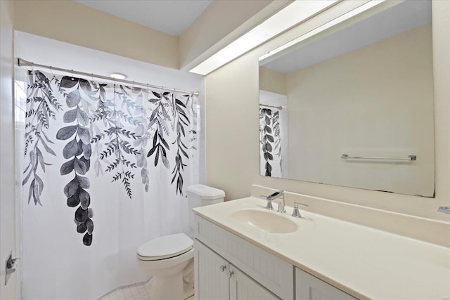 bathroom featuring tile patterned floors, vanity, toilet, and curtained shower