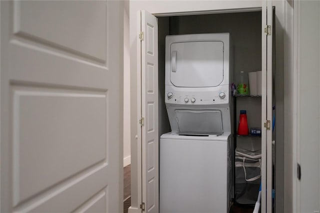 washroom featuring stacked washer / drying machine