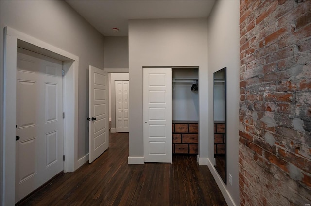 unfurnished bedroom with dark wood-type flooring and two closets