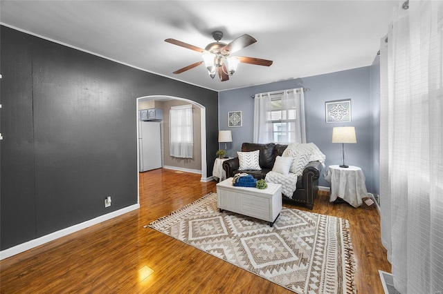 living room with hardwood / wood-style flooring and ceiling fan