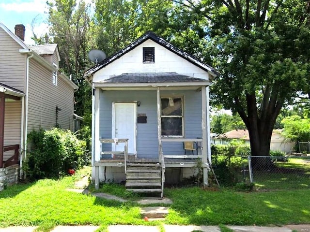 bungalow-style home featuring a front yard