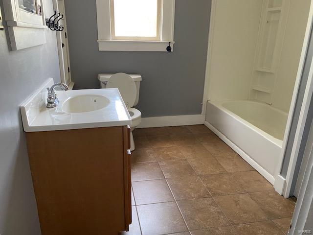 full bathroom with vanity, shower / bathtub combination, and toilet