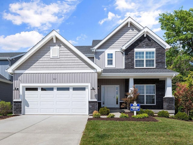 craftsman house featuring a porch, a garage, and a front yard