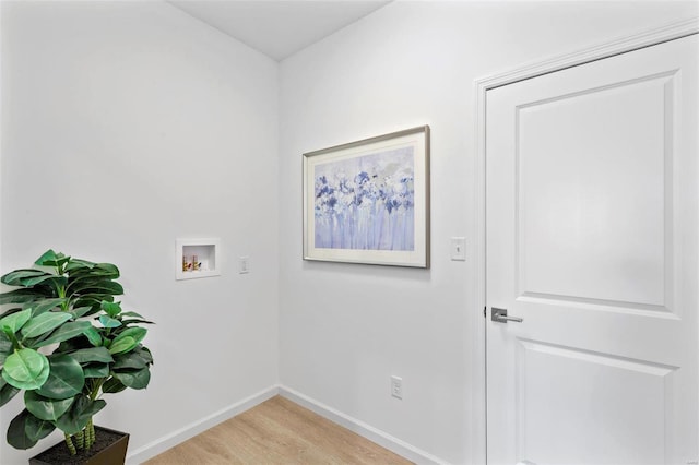 washroom with hookup for a washing machine and light hardwood / wood-style floors