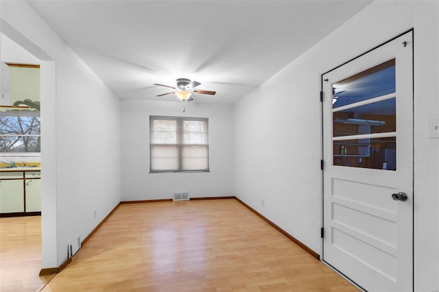 empty room featuring light wood-type flooring and sink