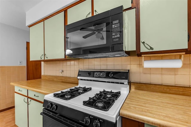 kitchen with light hardwood / wood-style flooring and white range with gas cooktop