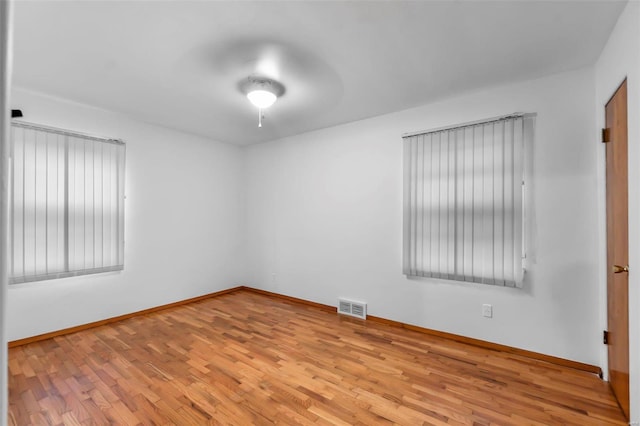 spare room with light wood-type flooring