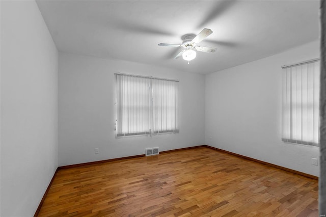 empty room featuring ceiling fan and light hardwood / wood-style flooring