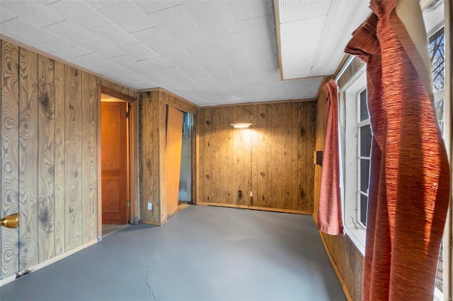 interior space featuring wooden walls and a healthy amount of sunlight