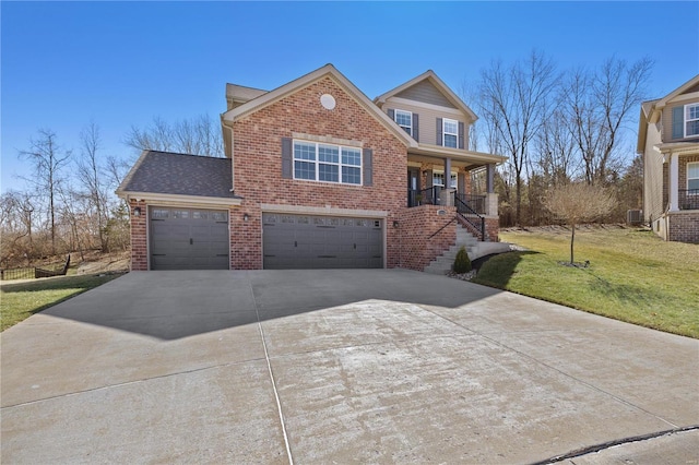 traditional home featuring brick siding, a shingled roof, covered porch, a front yard, and driveway