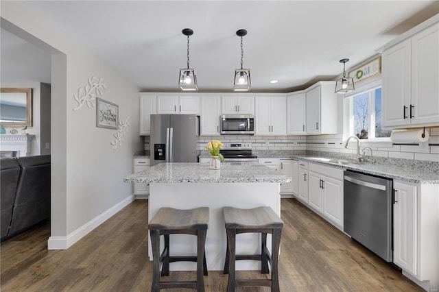 kitchen featuring appliances with stainless steel finishes, backsplash, and white cabinets