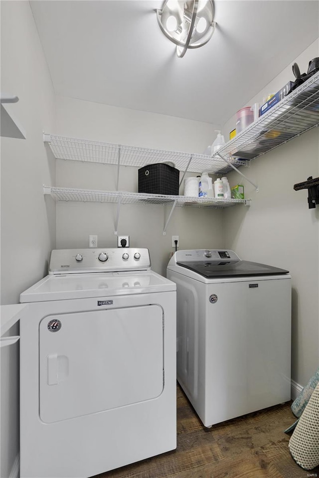 laundry area with laundry area, separate washer and dryer, and dark wood finished floors