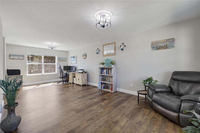 office with dark wood-style floors, a notable chandelier, and baseboards