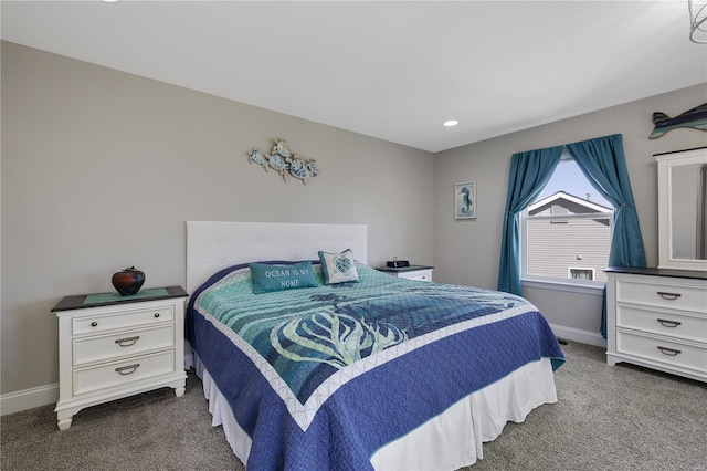 bedroom featuring baseboards and dark carpet