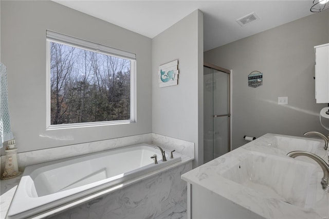 full bathroom featuring a bath, vanity, a shower stall, and visible vents