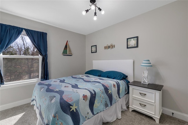 bedroom with carpet floors and baseboards