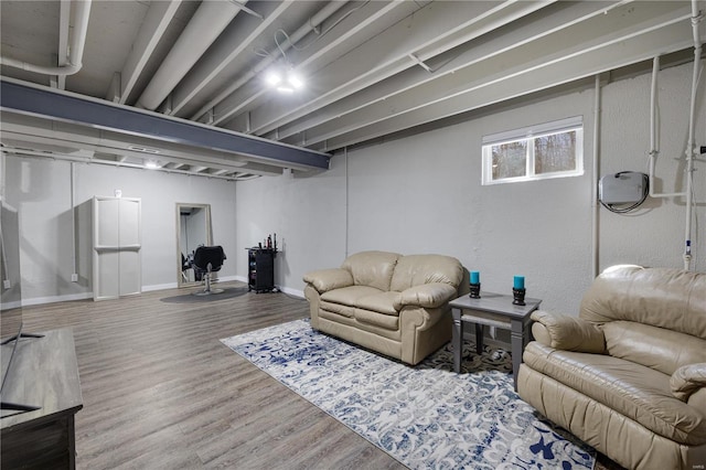 living area with baseboards and wood finished floors