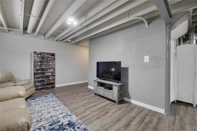 living area featuring baseboards and wood finished floors