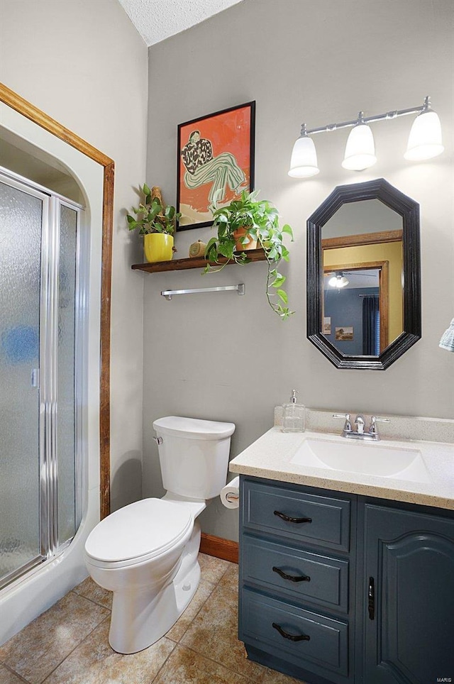 bathroom featuring tile patterned floors, a textured ceiling, toilet, a shower with door, and vanity