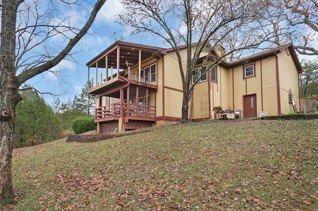 rear view of house featuring a deck