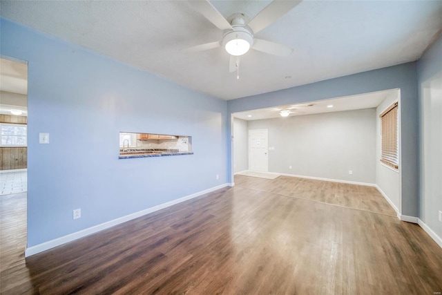 spare room with ceiling fan and wood-type flooring