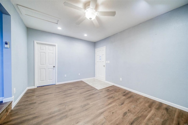 spare room featuring ceiling fan and hardwood / wood-style floors