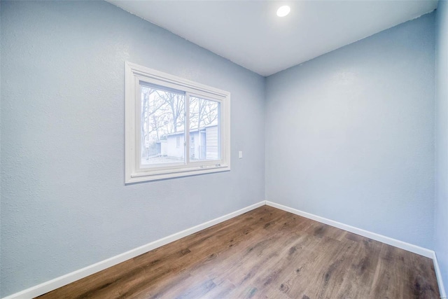 unfurnished room with wood-type flooring