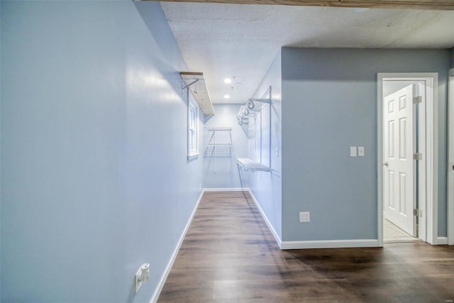 corridor featuring dark hardwood / wood-style floors and a textured ceiling