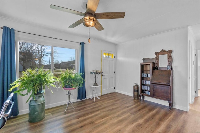 misc room with dark hardwood / wood-style floors, ceiling fan, and ornamental molding