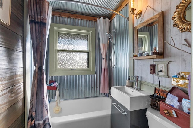 full bathroom featuring shower / bath combo, toilet, and vanity