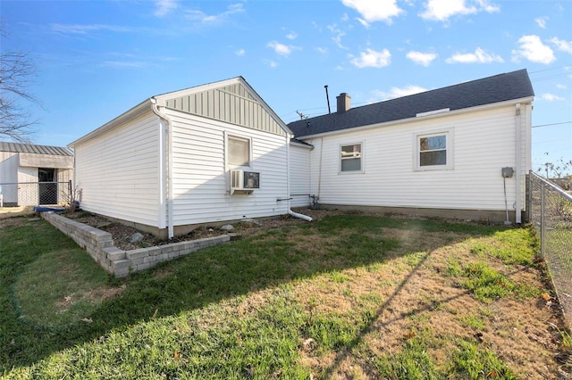 back of house featuring cooling unit and a yard